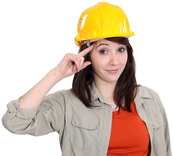 Saluting woman wearing a hard-hat and work attire.